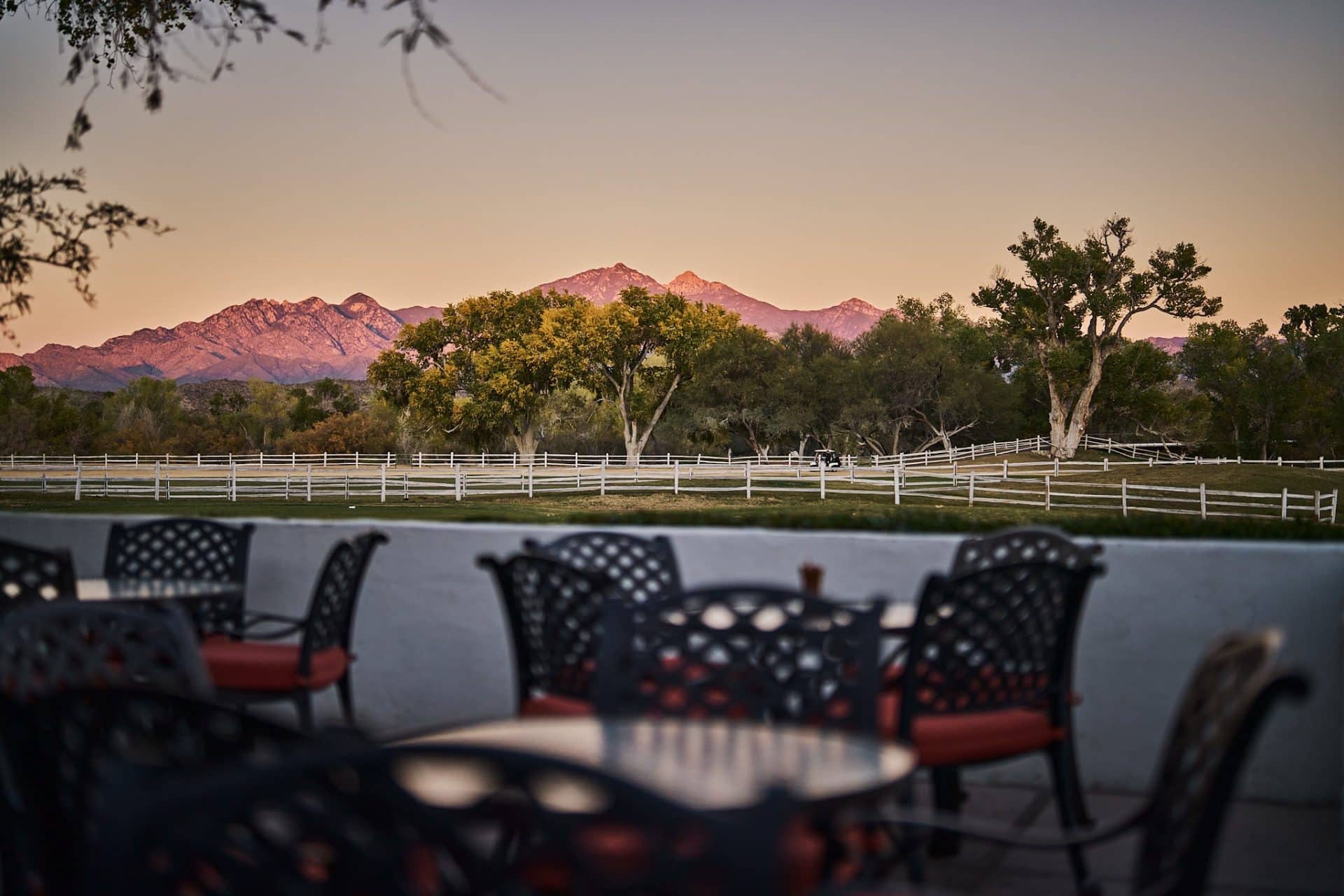 Sunset patio with seating overlooking trees and an Arizona mountain range