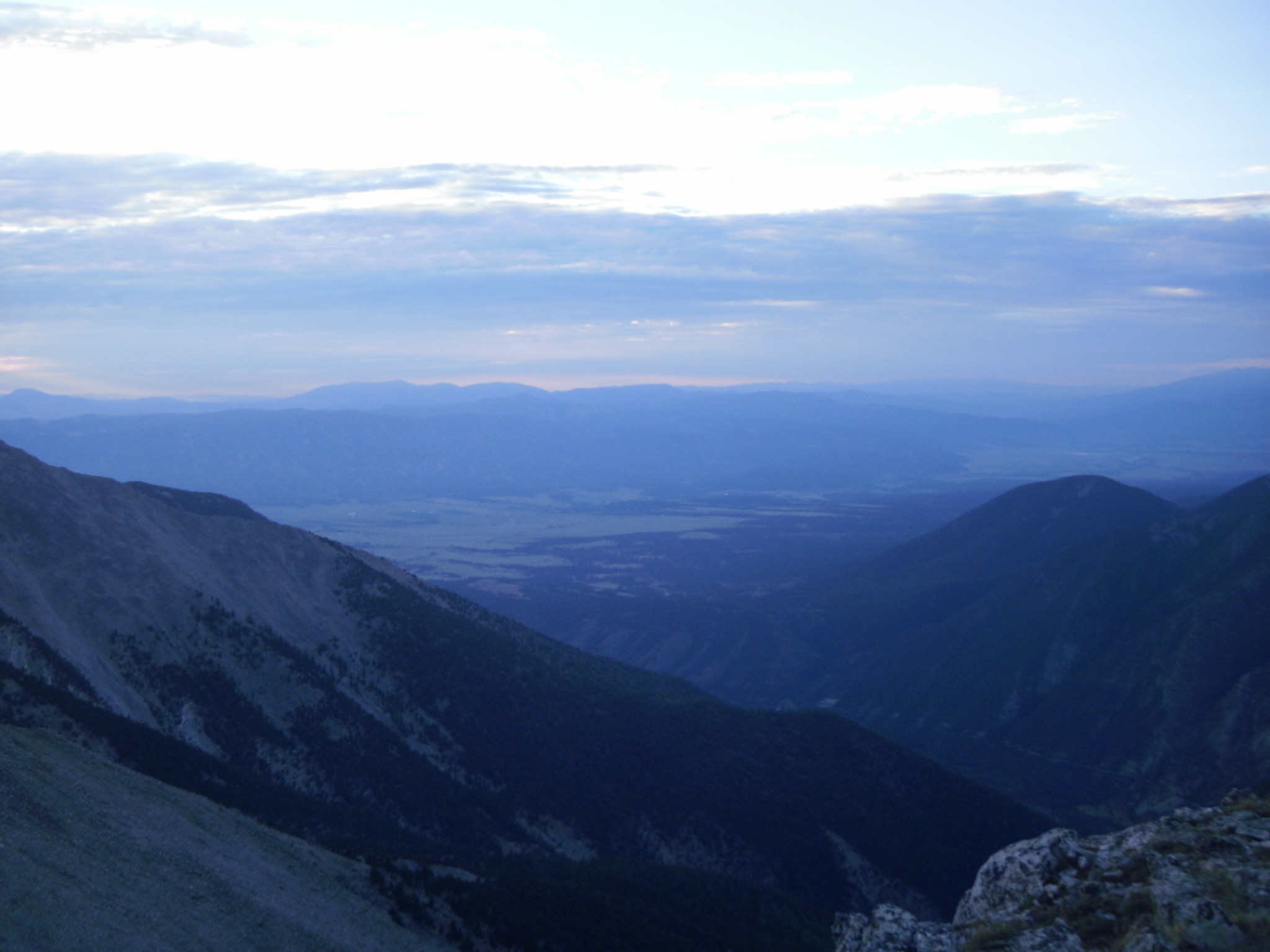 Sunrise view across Colorado mountain ridges and a distant valley